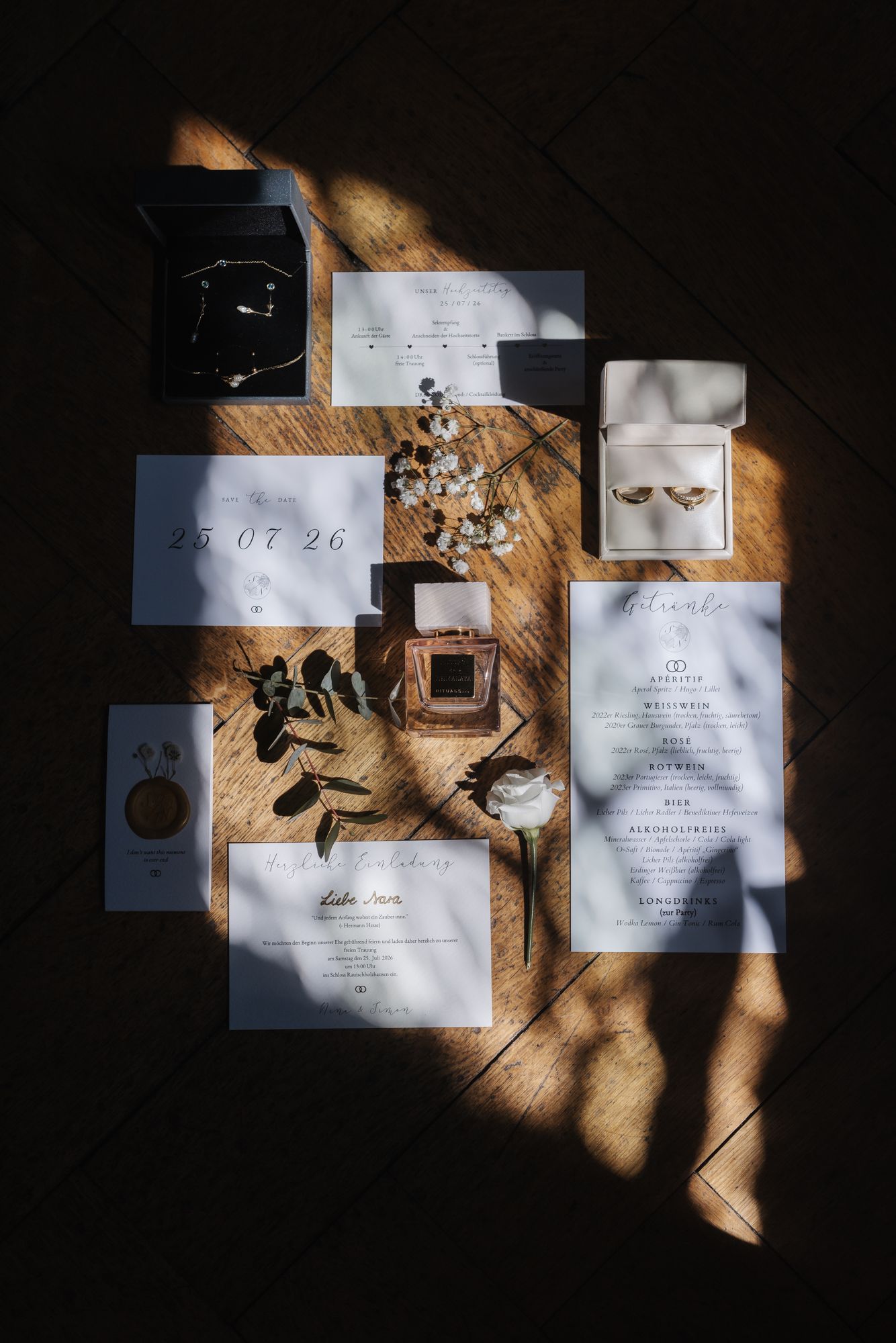 Invitation, rings and perfume in the sunlight while getting ready