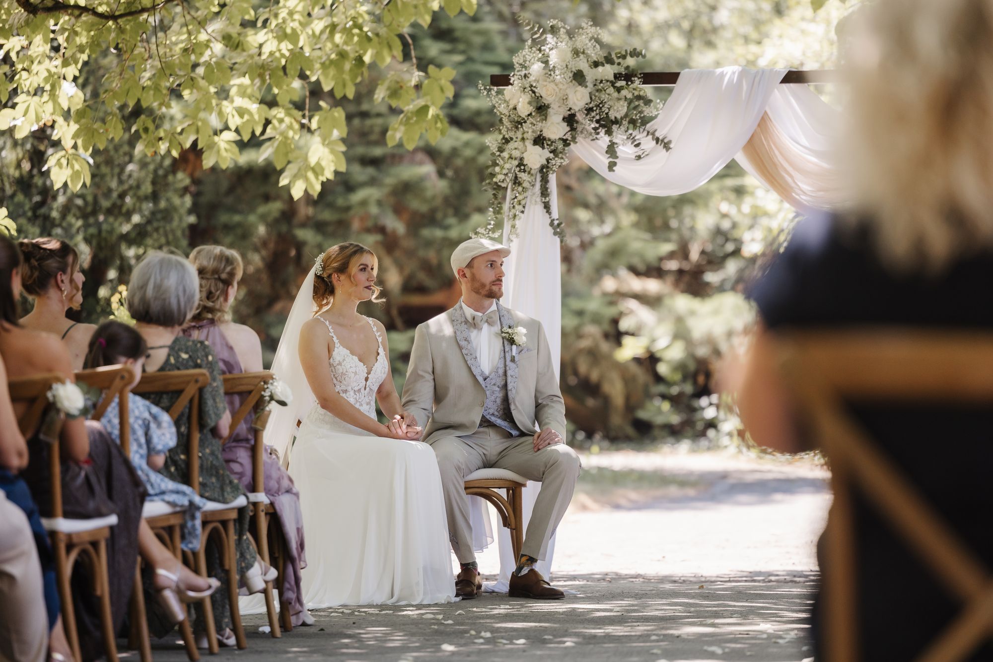 Couple at their outdoor wedding ceremony in the shaded castle park